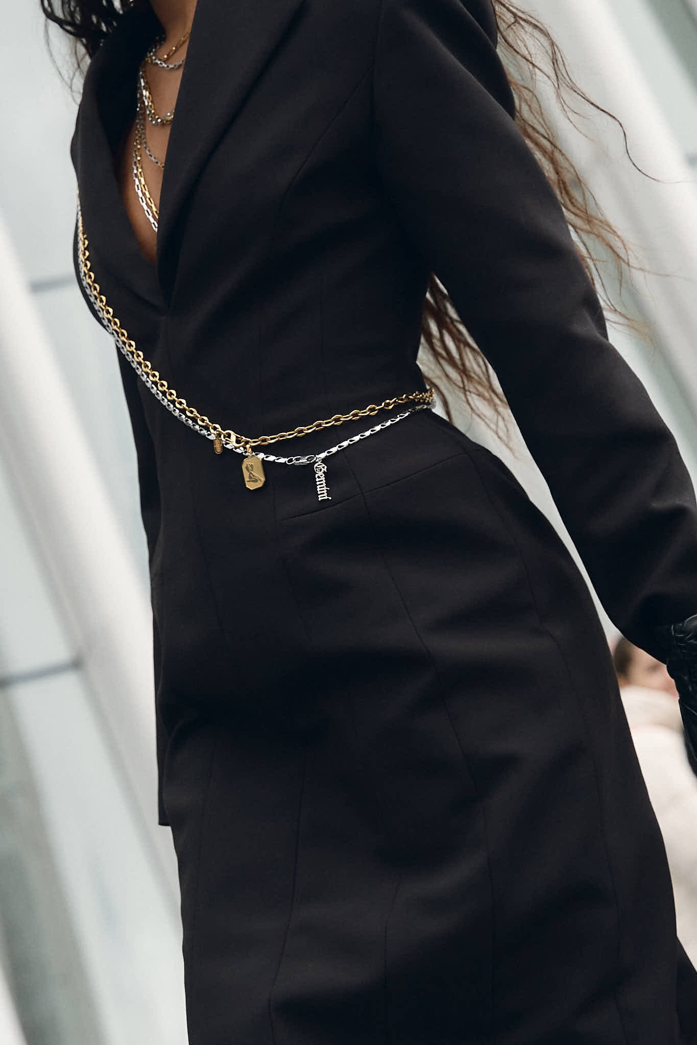 Opal wearing a black Zara blazer dress with Lapo Lounge chain belts draped across the chest and 3.1 Phillip Lim red Luna bag