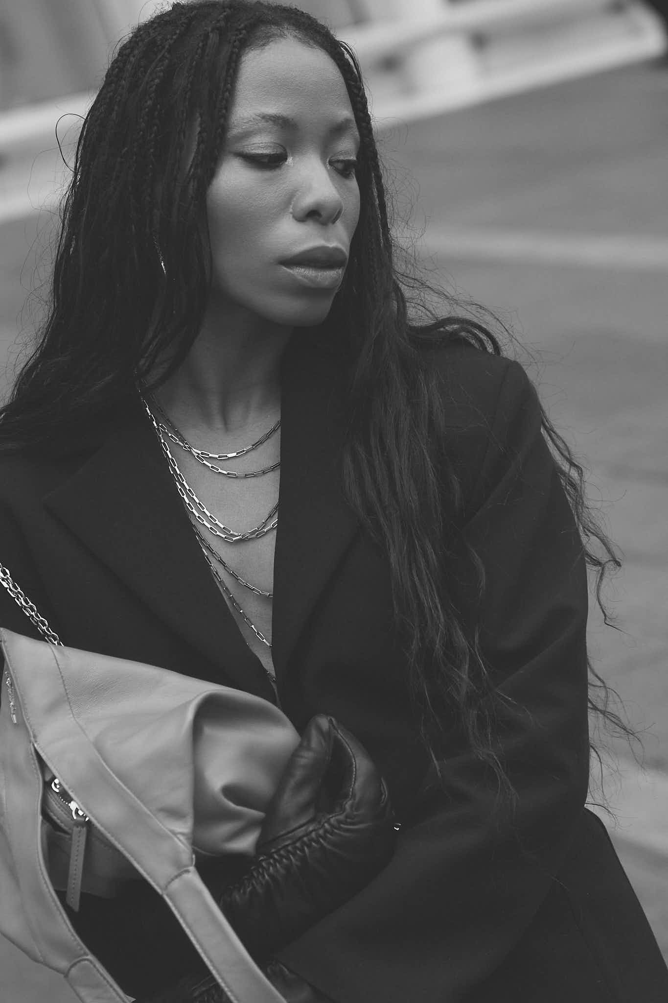 Opal wearing a black Zara blazer dress with Lapo Lounge chain belts draped across the chest and 3.1 Phillip Lim red Luna bag